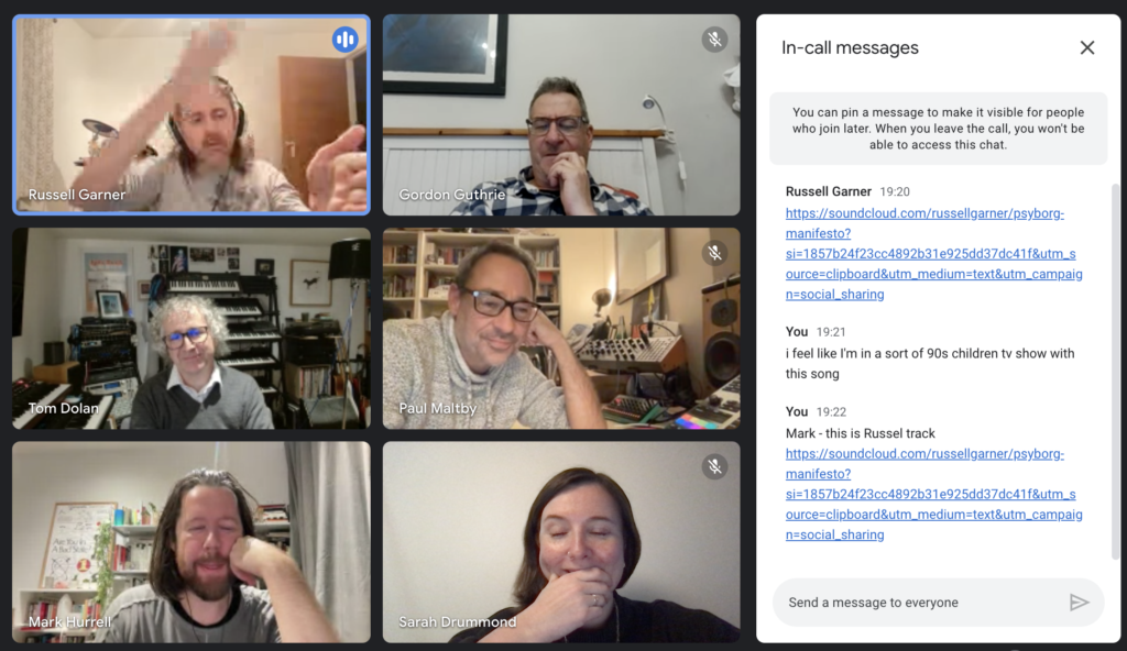 Images shows a group of white peopl , 5 men and one woman on a virtual call laughing with instruments in the background