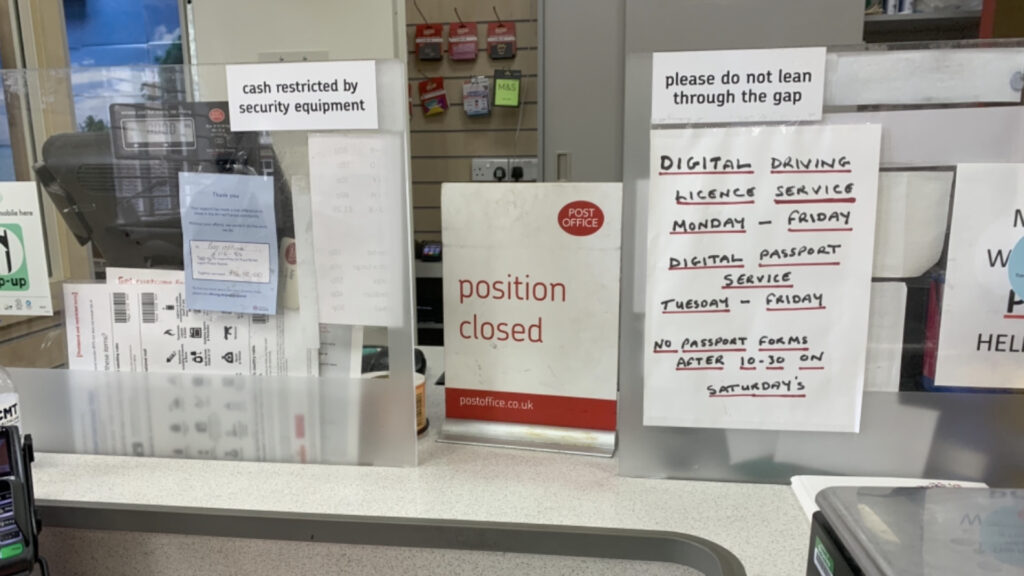 Slide shows a post office position closed with written sign on how to get a passport 